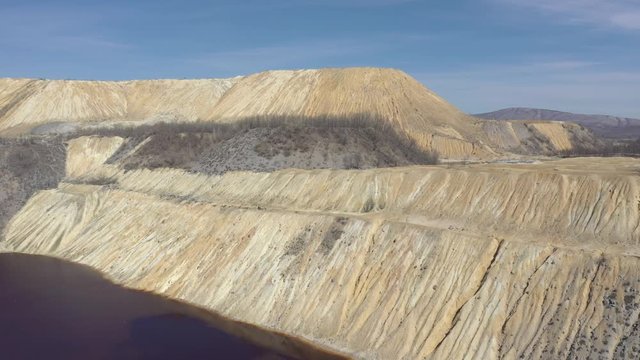 Open mining pit pyrite and red drainage waters 4K drone video