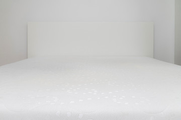 Close up of memory foam mattress on the bed frame at sleeping ro