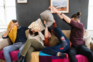 A group of young friends indoors at home, having fun. House sharing concept.