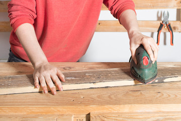woman sanding a restored wood