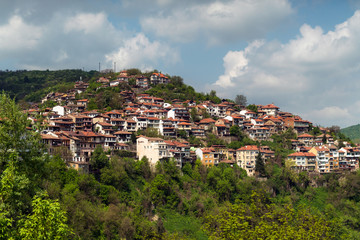 Fototapeta na wymiar Homes on the cliff among the mountain scenery. Balkan houses