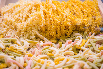 Fresh home made raw Italian pasta, close-up texture of tagliatelle pasta flour ribbon noodle