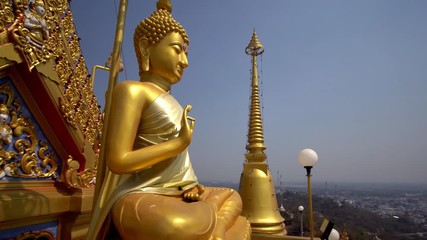 Giant Buddha statue at hilltop temple in Nakorn Sawan, Thailand.