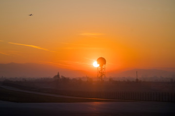 Rising sun over the airport. Early morning golden sunrise at the air port