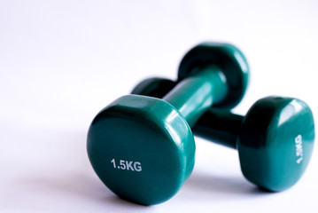 green dumbbells on white background