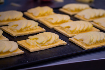 Artisan cakes of apple pie on a tray to be baked