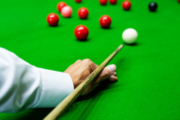 Game snooker billiards or opening frame player ready for the ball shot, athlete man kick cue on the...