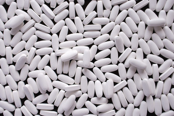 white pills on black background