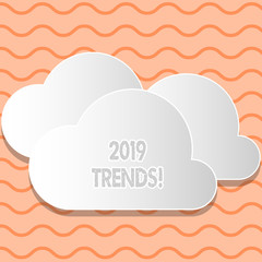 Writing note showing 2019 Trends. Business concept for general direction in which something is developing or changing White Clouds Cut Out of Board Floating on Top of Each Other
