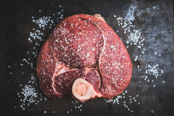 Raw fresh meat with salt on the rustic background. Selective focus. Shallow depth of field. 