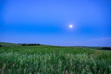 Field and hills on a summer evening