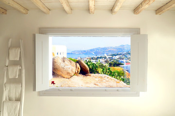 Magical white window offering a beautiful view of the island of Mykonos (Greece) in the Cyclades in the heart of the Aegean Sea