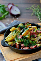 fried potatoes with sausages