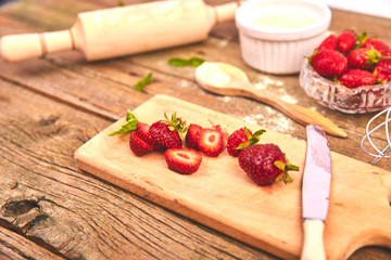 Strawberry on cutting board. Recipe for strawberry pie. Raw ingredients for cooking strawberry pie or cake on rustic background. Top view, flat lay. Copy space.