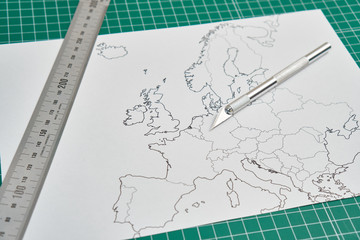 Fototapeta na wymiar europe map with a ruler and a cutter
