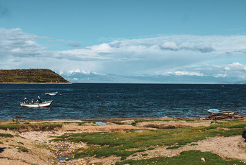 Small island with cloudy sky on lake titicaca in Bolivia