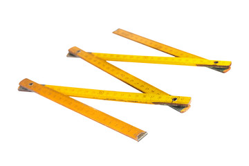 Old worn dirty wooden folding ruler yellow color with digits isolated on white background without shadow