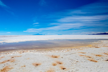 Landscape of incredibly white salt flat Salar de Uyuni, amid the Andes in southwest Bolivia, South America