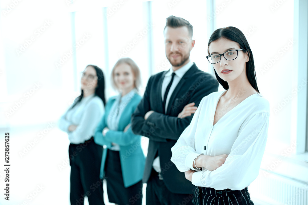 Wall mural successful business woman standing in front of her business team