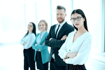 Fototapeta premium successful business woman standing in front of her business team