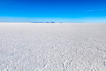 Landscape of incredibly white salt flat Salar de Uyuni, amid the Andes in southwest Bolivia, South America