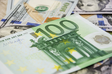 Obraz na płótnie Canvas 100 euro bill closeup on dollars background