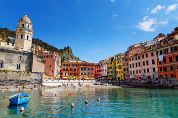 Naklejka premium Liguria, Italy coastline of Riviera with colorful houses on sunny warm day. Monterosso al Mare, Vernazza, Corniglia, Manarola and Riomaggiore, Cinque Terre National Park UNESCO World Heritage