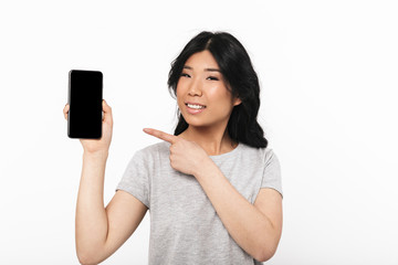 Beautiful young woman posing isolated over white wall background showing display of mobile phone.