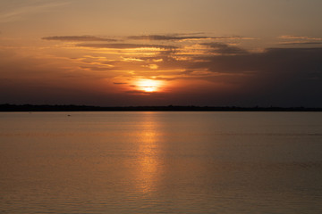Sunset on the lake, reflection in the water, sun path,