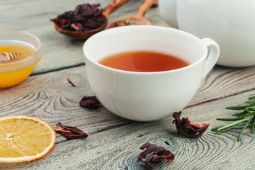 Cup of tea and tea leaves on wooden table
