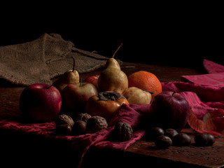 still life of winter fruits on wooden table and purple cloth © Massimo Gennari
