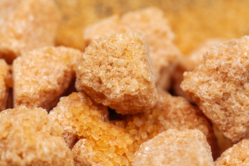 Brown cane sugar cubes isolated on white background