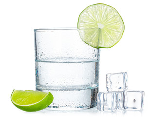 Obraz na płótnie Canvas Shot of tequila with a slice of lime no white background