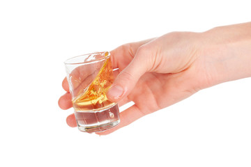 Man's hand holding a glass with  tequila