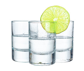 Three  tequila shots with lime isolated on white background
