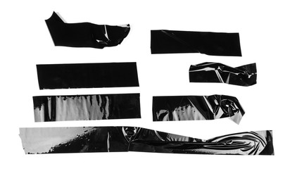 Torn different size black sticky tape, adhesive pieces