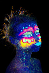 Blue woman portrait, aliens sleeps, ultraviolet make-up.  Beautiful on a dark background. She closed her eyes and smiles.