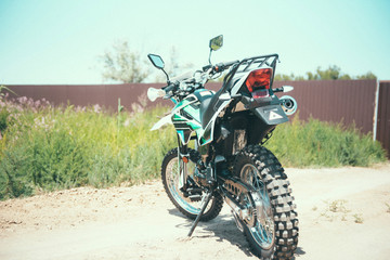 Fototapeta na wymiar motocross bike stands on a sandy road