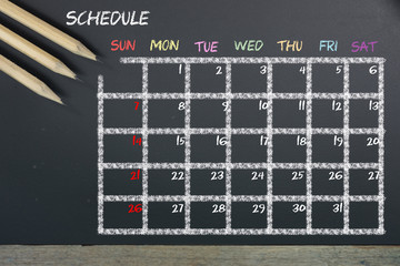 Schedule with grid time table on black chalkboard background