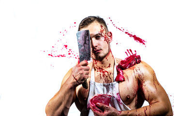 At butcher shop. Butcher chopping red meat. Handsome man cutting raw steak with butcher axe in muscular hands. Strong man wearing butcher apron with blood stains