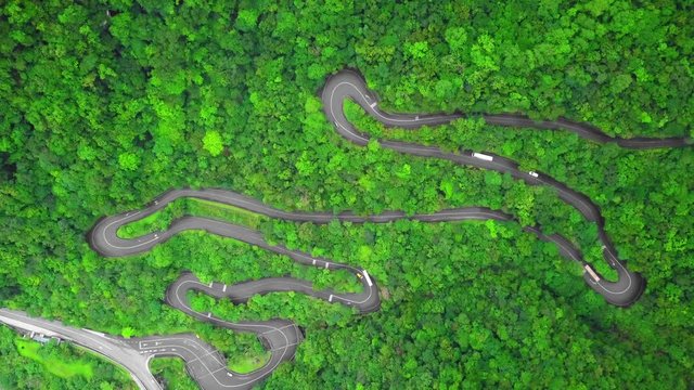 Winding Road with Transport Traffic among Green Lush Forest Trees in Taroko Gorge National Park in Taiwan. Aerial Top View