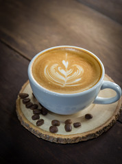 Hot coffee in a wooden tray
