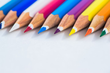 colored pencils on a pastel background to a point with space for text.