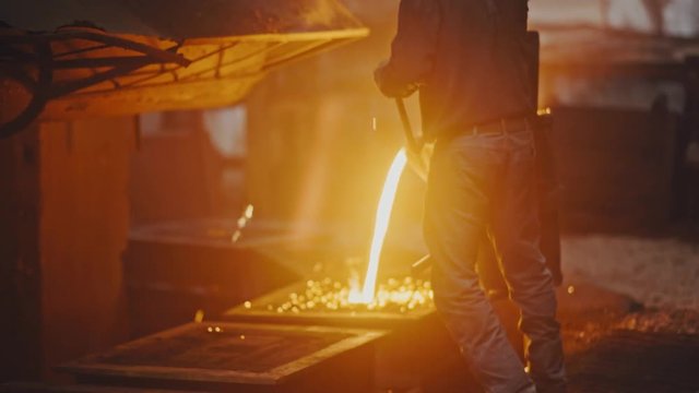 Hard work in the foundry. Pouring molten steel. Liquid steel pouring. Molten metal pouring, metallurgy, steel casting foundry. Steel manufacturing