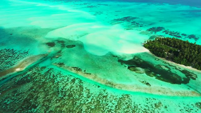 aerial drone shot of crystal clear emerald see and Uncontaminated coastline of tropical Caribbean Coral Reef Atoll