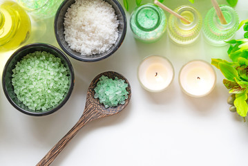 Thai Spa Treatments aroma therapy salt and nature green sugar scrub and rock massage with green orchid flower on wooden white with candle. Thailand. Healthy Concept.