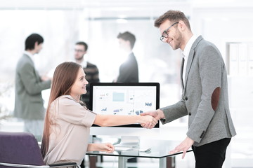 Manager and employee shaking hands to each other as a sign of success