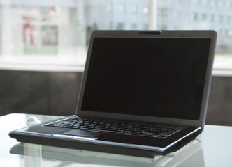 open laptop on glass table in modern office