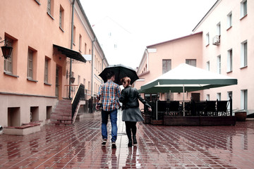 rear view. loving couple on the street on a rainy day
