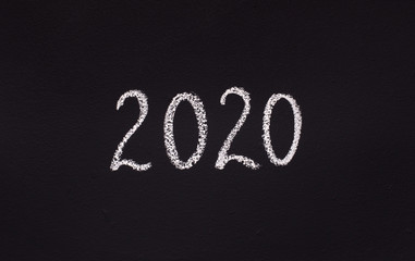 White chalk 2020 concept writing on black board
